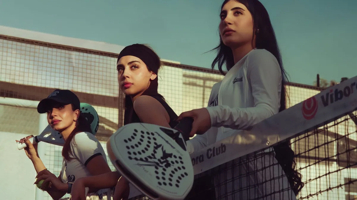 Three women play padel tennis at a court in Baghdad, Iraq.