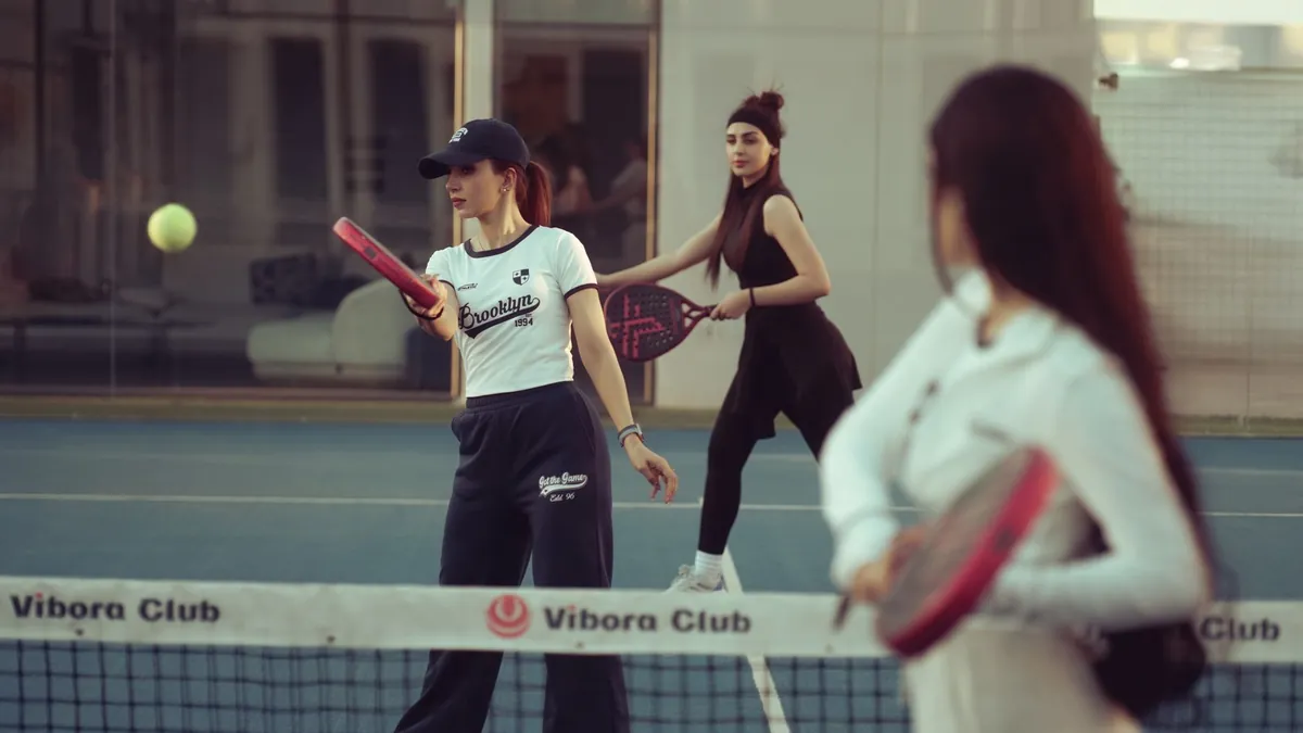 Group of women enjoying a padel match at Vibora Club in Baghdad, Iraq.